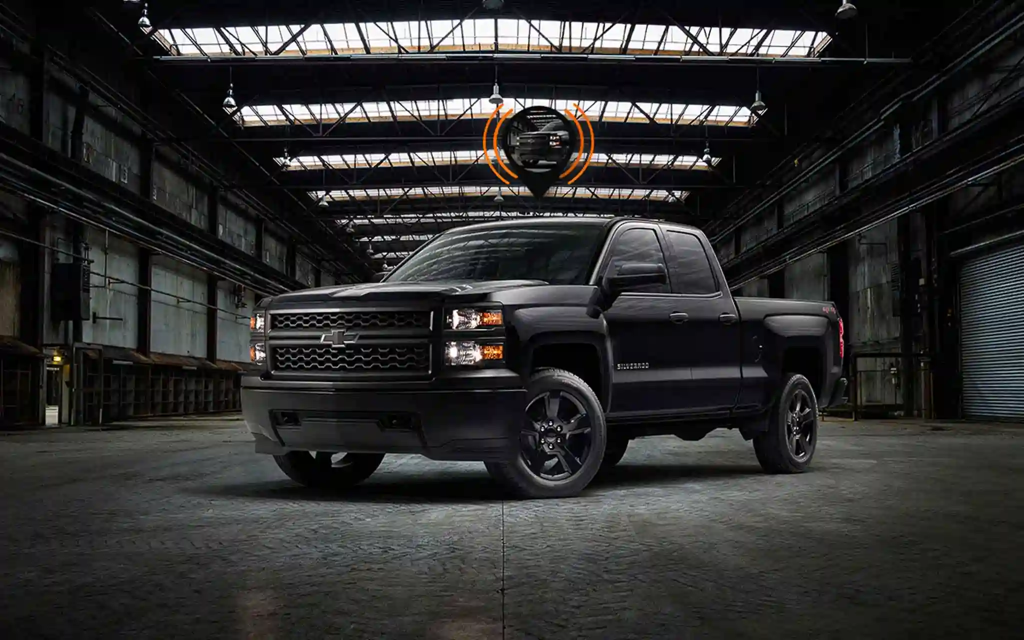 A black car on a garage with GPS tracker for car installed in it.