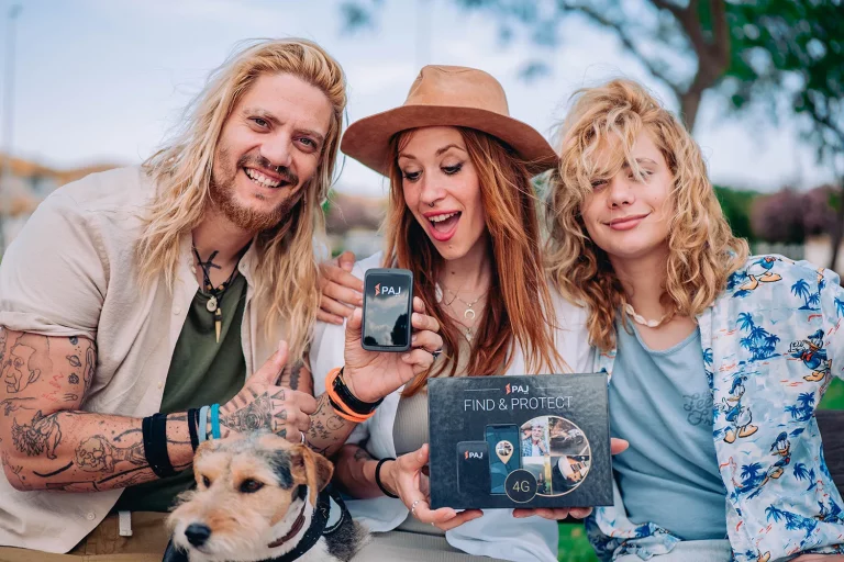 two ladies and man along with dog giving thumps up to GPS tracker