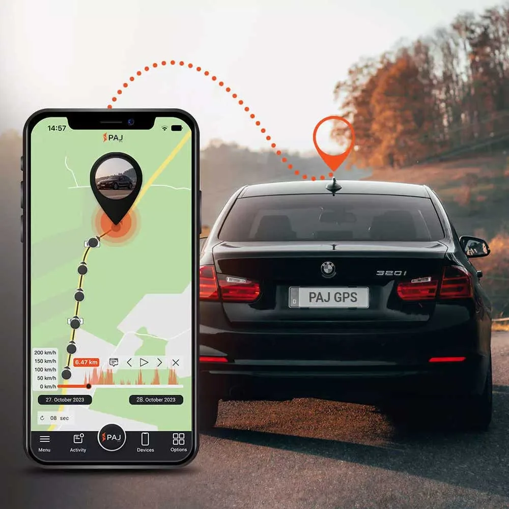 A black car on road and with a car gps location tracker, on its side a mobile running paj finder portal application with live tracking.